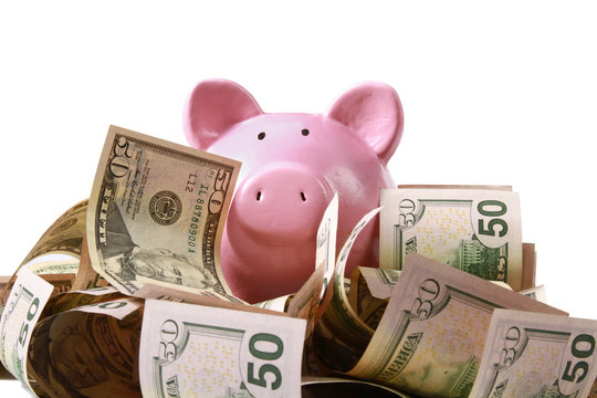 piggy bank standing on dollars