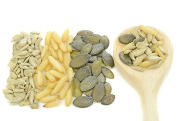 Pine nuts, sunflower, pumpkin seeds with wooden spoon