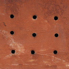 Painted grungy metal surface with holes