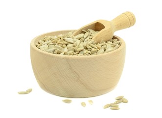 A bowl of sunflower seeds with wooden scoop on white background
