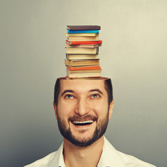 man looking up at books in the head