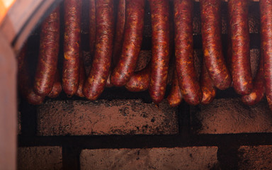 Traditional food. Smoked sausuages in smokehouse.