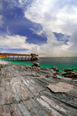 Jetty by a rocky beach in Pulau Kapas, Terengganu Malaysia