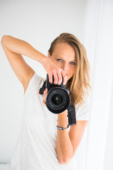 Pretty, female photographer with digital camera