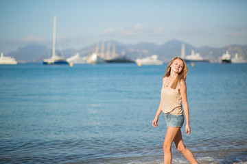 Young girl enjoying her vacation by the sea