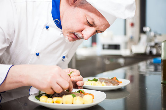 Chef garnishing a dish