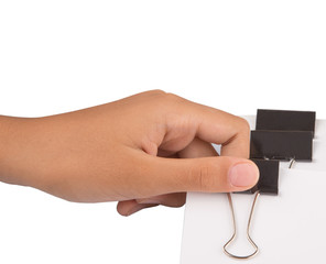 Female hand holding white paper with binder clips
