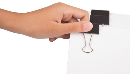 Female hand holding white paper with binder clips 