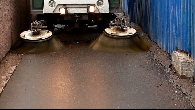 Cleaning equipment brushing asphalt, concrete road