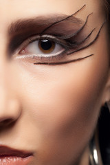 Close shot of an eye with gothic make up