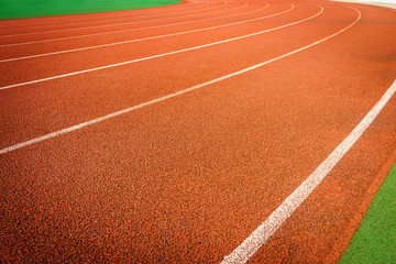 A running racetrack constructed from red rubber cover