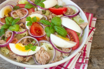 salad with tuna, eggs, tomatoes, onions and basil