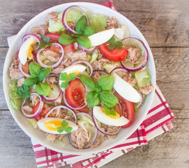 salad with tuna, eggs, tomatoes, onions and basil