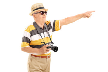 Mature tourist pointing at something with hand
