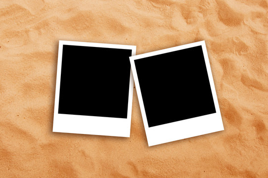 Two Blank photo frames on beach sand