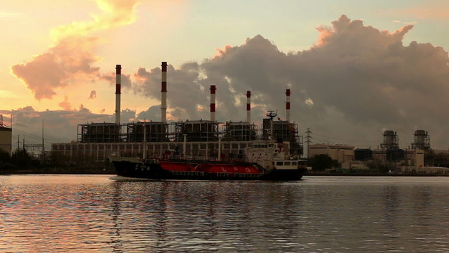 Gas(LPG) tanker at sunrise on electric power station background