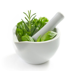 green herb leaves in a white pestle