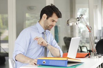 Young businessman working on laptop