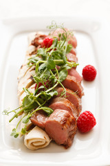 grilled duck breast covered with sweet red fruit sauce