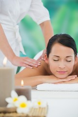 Obraz na płótnie Canvas Beautiful brunette enjoying a back massage