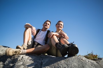 Hiking couple looking out over mountain terrain