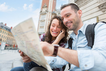 Young couple of tourists booking an activity