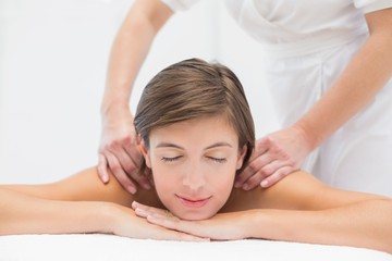 Fototapeta premium Attractive woman receiving shoulder massage at spa center