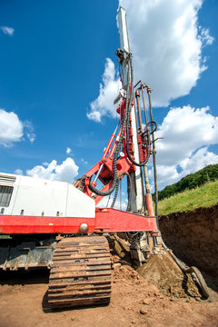Industrial drilling rig at construction site making holes