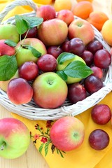 Fresh fruits with leaves in basket.