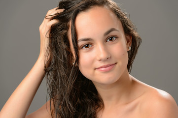 Fototapeta premium Teenage girl touch wet hair care cosmetics