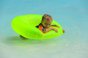 little boy swimming at the beach