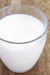 close - up cup of milk on wood table