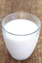 close - up cup of milk on wood table