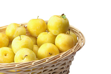Yellow plums in wicker basket