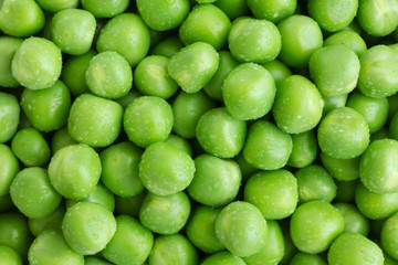 Fresh garden peas shot from above. Wet.