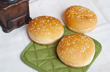 Three round sandwich bun with sesame seeds