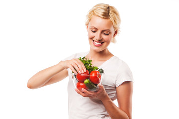 Close-up of happy healthy woman holding fresh vegetable salad in