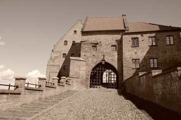 Fototapeta na wymiar Grudziadz, Poland - old medieval city gate. Sepia toned image.