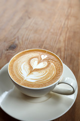Cup of latte coffee on wooden