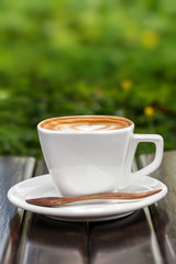 Cup of latte coffee on wooden