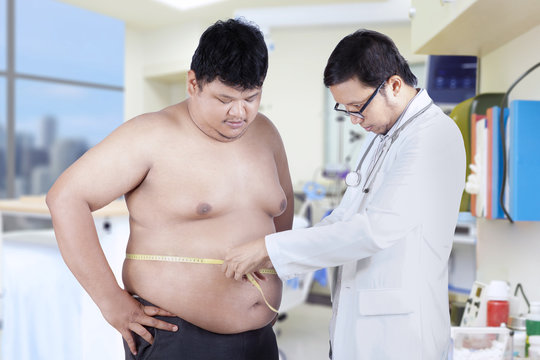 Doctor measuring a patient obesity