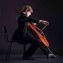 Cellist playing classical music on cello © papa