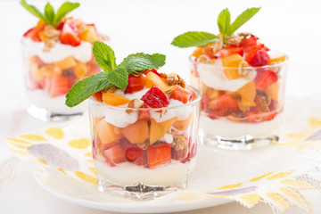 dessert with fresh strawberries, apricots, cream and granola