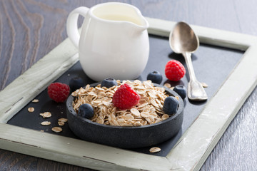 healthy food - cereal, fresh berries and jug of milk