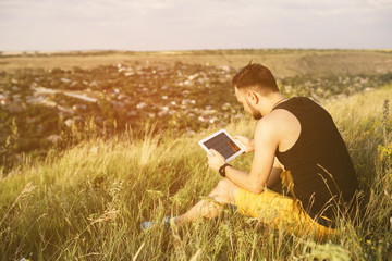 Man working outdoors with tablet pad. Retro vintage instagram fi