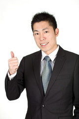 Fototapeta na wymiar young asian business man lift his thumb to commend someone