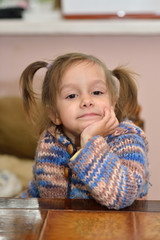 Cute little girl at table