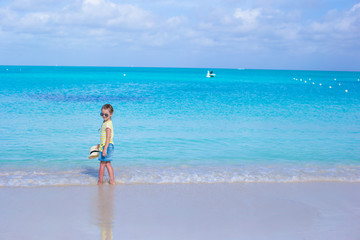 Fototapeta na wymiar Little girl in sunglasses at beach during summer vacation
