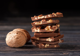 Chocolate with nuts on wooden background