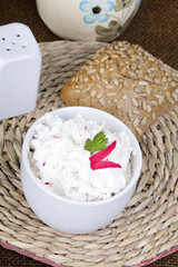 cottage cheese with radish, milk jug and wholemeal bun